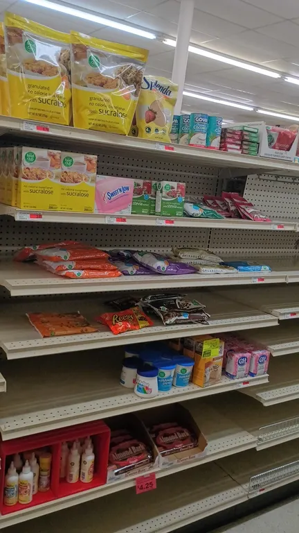Assorted baking and sweetener grocery inventory from a 4' shelf section. Includes almond bark, marshmallow creme, chocolate and baking chips, pecans,