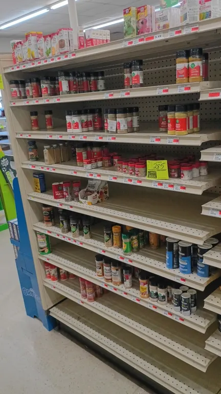 Contents of 4' shelving section. Includes assorted salts, seasonings, spices, food coloring, and extracts. Brands include McCormick, Food Club, Morton
