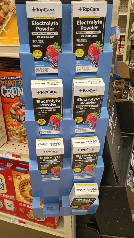 TopCare Health electrolyte powder retail display. Includes TopCare Health Advantage Care Berry Frost electrolyte powder boxes (0.6 oz packets, 3.6 oz