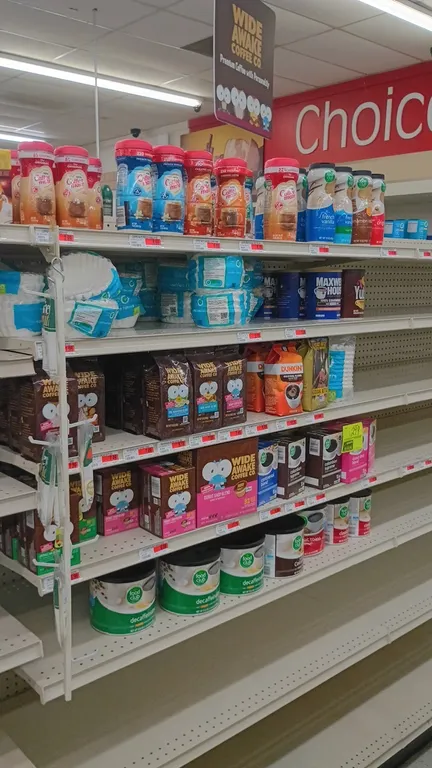 Contents of 4' shelving section. Includes assorted ground coffee, canned coffee, single-serve coffee pods, coffee filters, and powdered coffee creamer