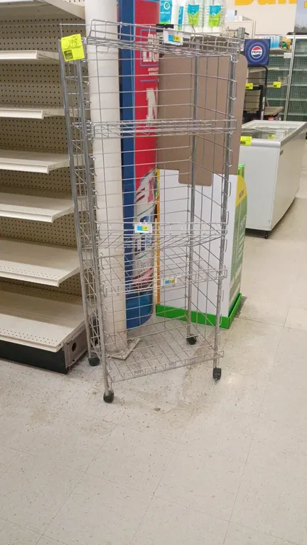5-tier wire display rack. Features metal wire construction with 5 tiers of wire shelving. Mounted on swivel casters.