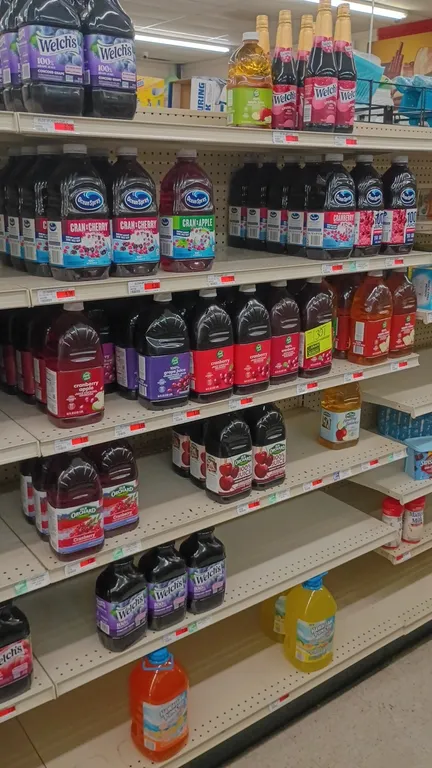 Assorted bottled juice inventory. Contents of 4' shelving section. Includes Ocean Spray cranberry blends, Welch's 100% grape juice and sparkling juice