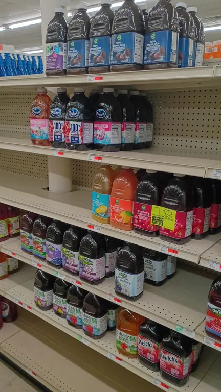 Contents of 4' section of assorted bottled juices. Includes various brands and flavors such as Food Club, Ocean Spray, Old Orchard, Juicy Juice, and W