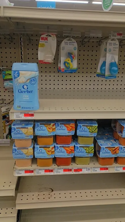 Contents of 4' section of retail shelving. Includes assorted baby food (Gerber purees, meats, and rice cereal), infant formula (Similac, Enfamil), Luv