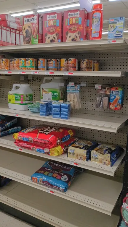 Assorted pet supplies inventory from an 8' shelving section. Includes dry dog food, canned dog food, dog treats, cat litter, pet shampoo, collars, and
