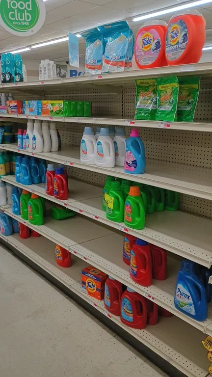 Assorted laundry care products from an 8' section. Includes Tide powder and pods, Purex detergent, Simply Done detergent, Snuggle and Downy fabric sof