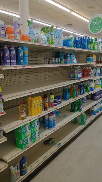 Contents of 8' shelving section. Includes bleach, Spray 'n Wash, Shout, Woolite, Ajax dish soap, Lysol laundry sanitizer, and assorted laundry and cle