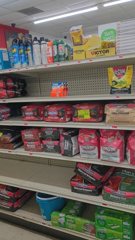 Contents of 4' shelving section. Includes assorted charcoal (Kingsford, CharKing), plastic mop bucket, Swiffer Sweeper starter kits and refill cloths,