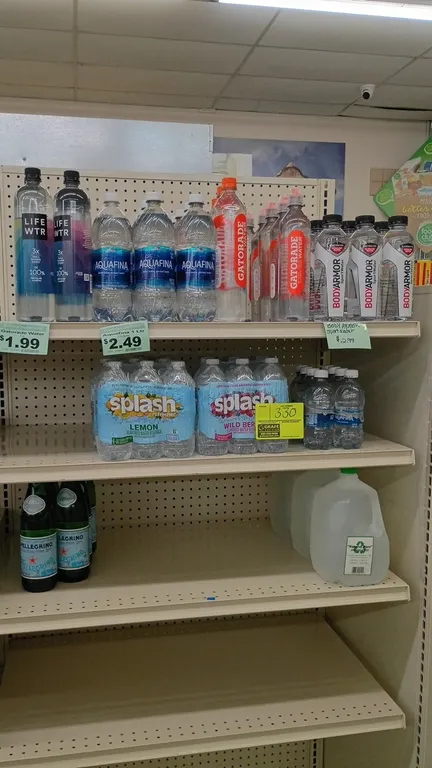 Assorted bottled water and flavored water beverage inventory. Includes brands such as Aquafina, Lifewtr, Gatorade Water, BodyArmor, Splash Refresher m