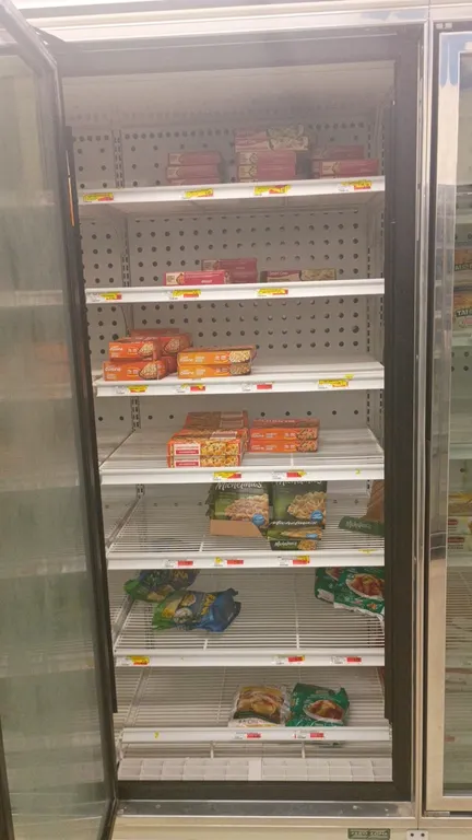 Assorted frozen food inventory. Contents of 4 frozen food doors. Includes assorted packaged frozen meals, entrees, and side dishes from brands includi