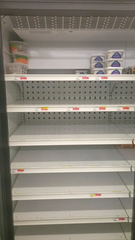 Assorted refrigerated grocery contents from 9 refrigerator doors. Includes various juices, coffee creamers, dairy dips, butter and margarine spreads,