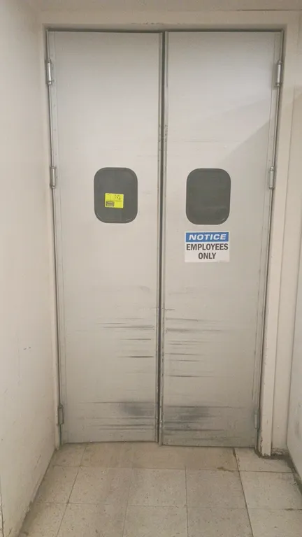 Aluminum double swing doors. Features aluminum construction and polycarbonate viewing windows. Dimensions: 24"W x 93"H.