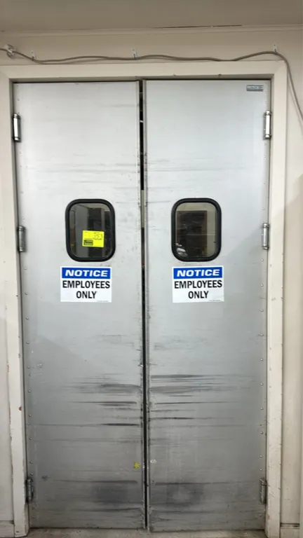 Double aluminum swing doors. Features integrated viewing windows, mounting hinges, and lower protective kick plates. Dimensions: 23.5"W x 87.5"H per p