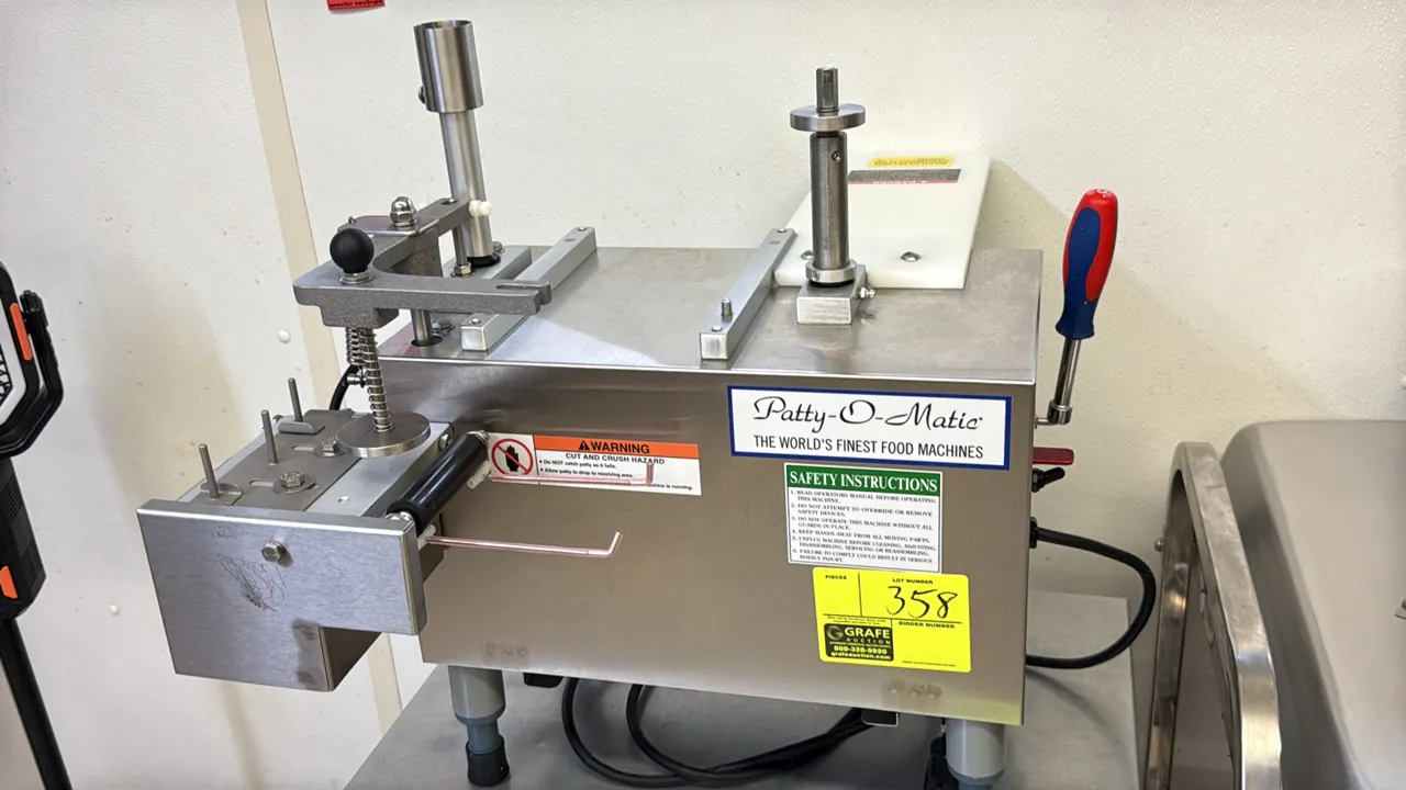 Patty-O-Matic PR12 patty former machine. Features stainless steel construction, 1/3 HP motor, and included tub of molds and attachments. S/N: 20131. E