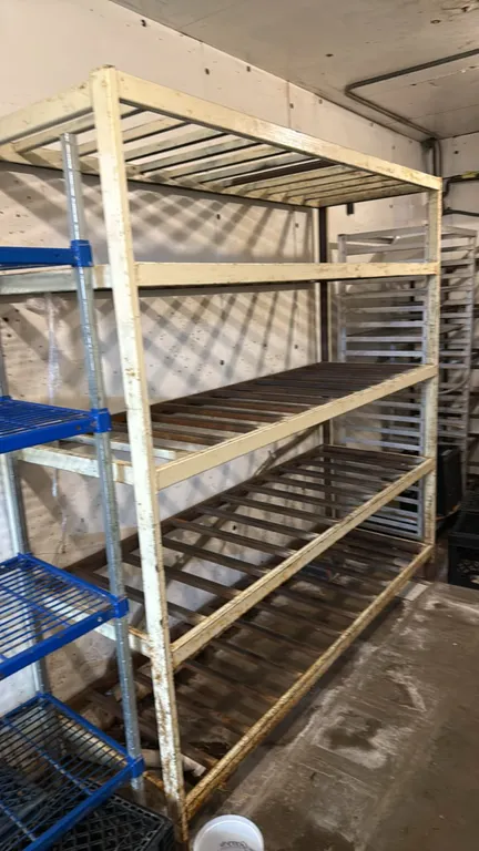 Metal 5-tier slatted storage rack. Features welded steel frame construction and 5 fixed slatted shelves. 74" x 76".