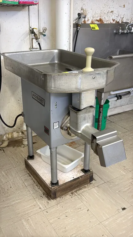 Hobart 4732 commercial meat grinder. Features stainless steel feed pan, safety guard, meat stomper, discharge guard, and spanner wrench. S/N: 11-420-3