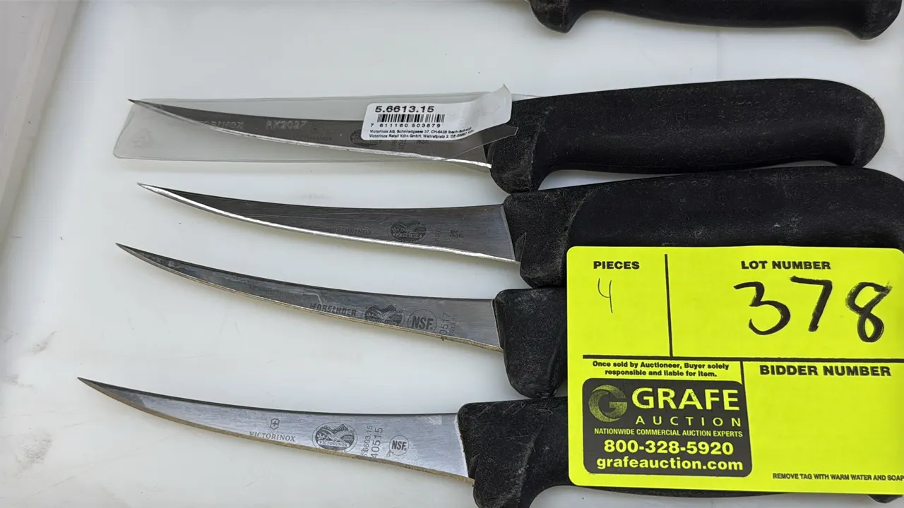 Victorinox boning knives. Features curved stainless steel blades and black textured non-slip synthetic handles. NSF certified.