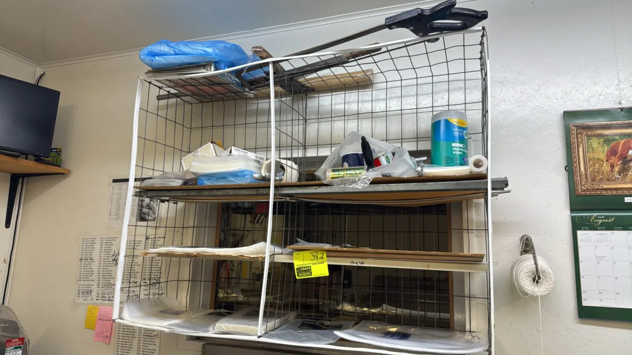 Metal wire storage rack. 44"W. Includes manual meat saw and assorted vacuum packaging bags.