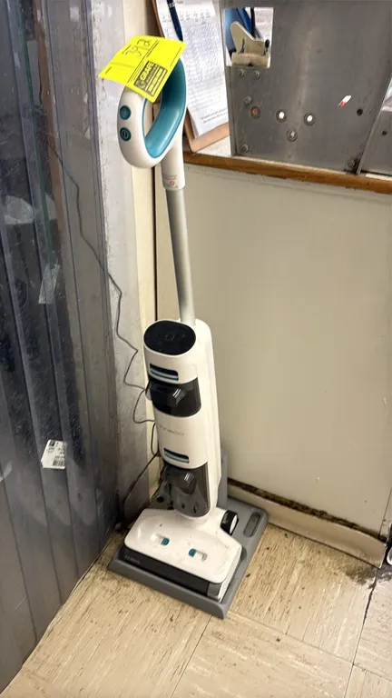 Tineco cordless wet and dry vacuum floor cleaner. Features dual water tank design, integrated handle controls, motorized roller brush head, and chargi