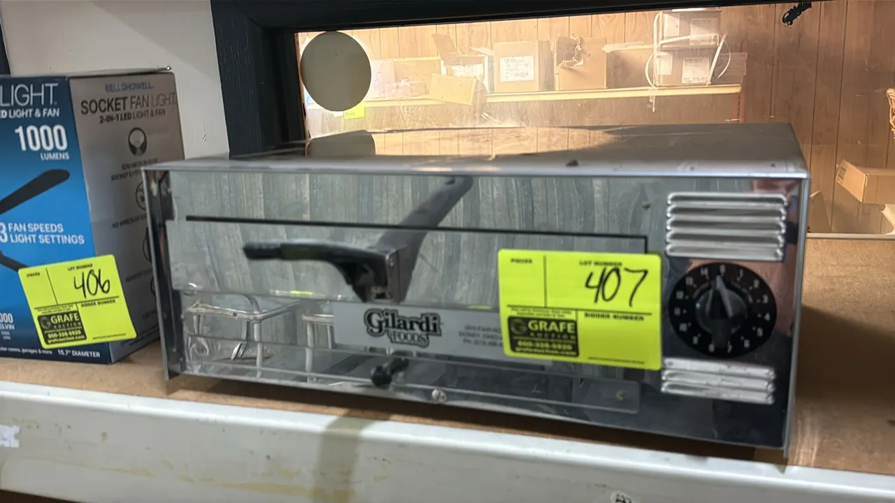 Gilardi Foods countertop pizza oven. Features stainless steel construction, pull-out wire rack with handle, and a 15-minute mechanical timer dial.