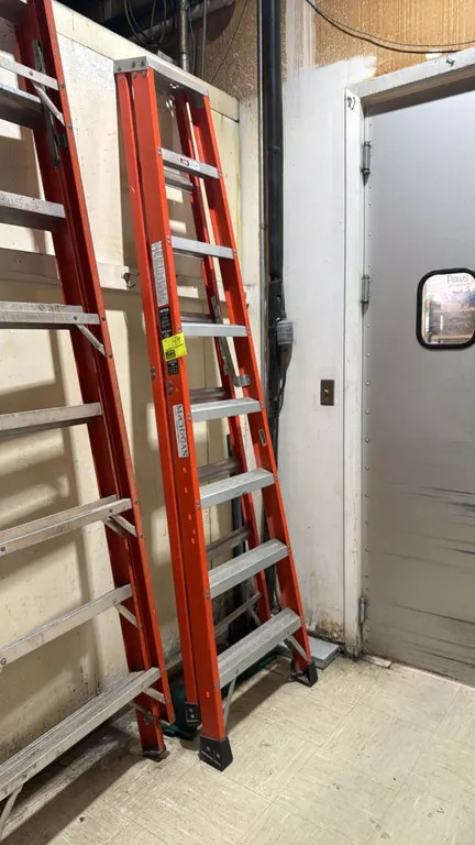 Michigan fiberglass stepladder. Features orange non-conductive fiberglass rails, aluminum steps, and slip-resistant feet. 8'H. Ladder to the left not