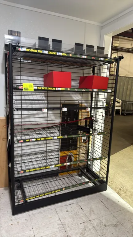 Portable metal endcap display rack. Features black wire construction, tiered wire shelves with price tag channels, and a top acrylic organizer shelf.