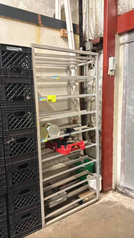 Aluminum 27-slot can rack. Features slanted gravity-feed runners designed for #10 cans. Stationary welded aluminum frame construction. Contents and su