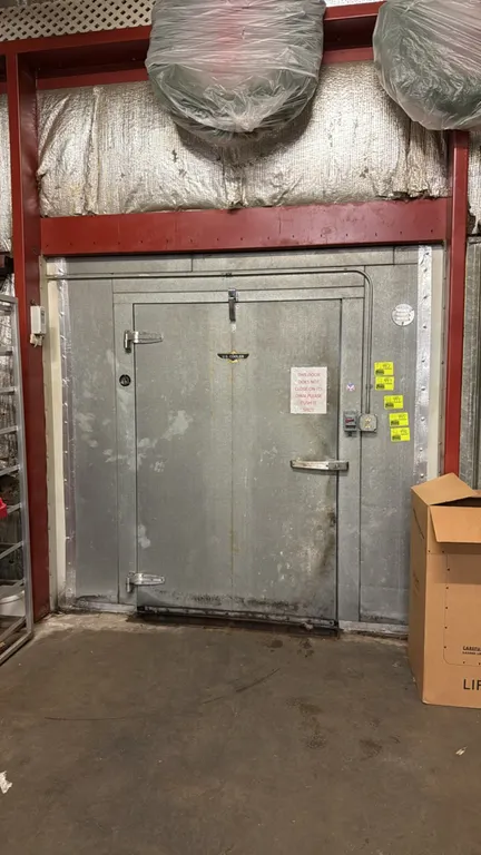 US Cooler walk-in freezer. Features insulated foam panels, pallet-width entry door, evaporator coil, and interior lighting. 13.5' x 13.5' x 7.5'H. Con