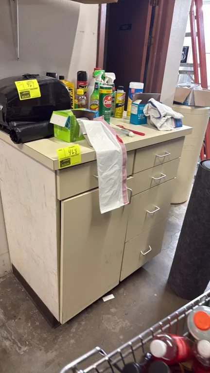Laminate storage cabinet. Features a laminate top, (1) lower cabinet door, and (5) storage drawers with wire pull handles. 38"W. Contents not included