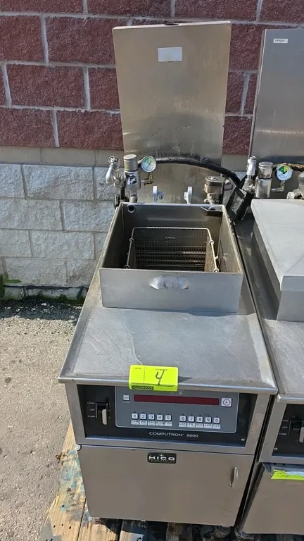 Henny Penny 500 electric pressure fryer. Features Computron 8000 digital controls, stainless steel construction, wire fry basket, and built-in filtrat