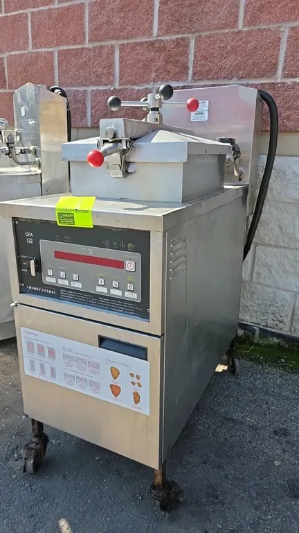 Henny Penny 500C electric pressure fryer. Features stainless steel construction, digital control panel, locking lid assembly, and built-in filtration