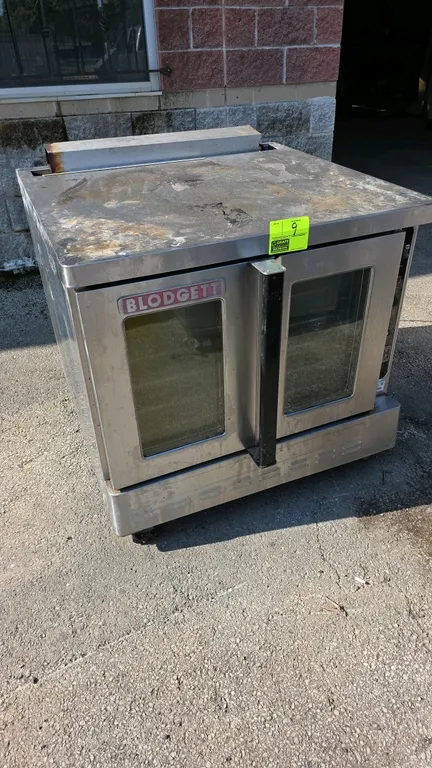 Blodgett gas convection oven. Features stainless steel construction, double doors with glass viewing windows, digital control panel, and (5) interior