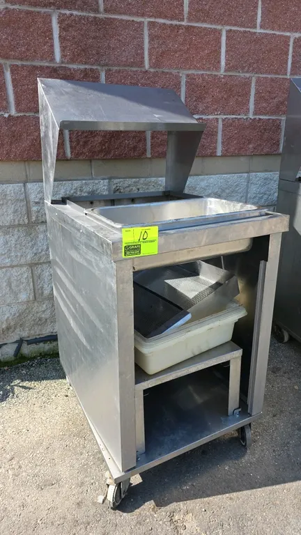 Stainless steel portable breading station. Features stainless steel construction, overhead shelf hood, drop-in well with stainless steel pan, and lowe