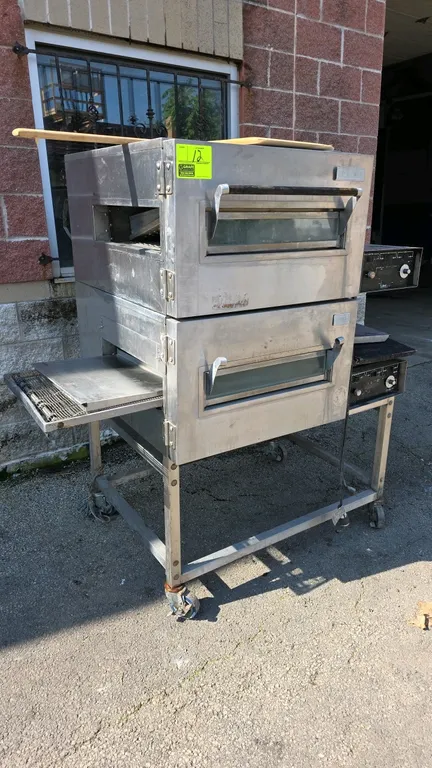 Lincoln 1116 Impinger double-stack gas conveyor oven. Features stainless steel construction, glass access doors, 19" x 4.5" openings, and wire mesh co