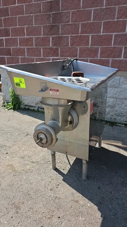 Biro 548 commercial meat grinder. Features stainless steel hopper with safety feed guard, 5 HP motor, foot switch, and side ON/OFF control lever. S/N: