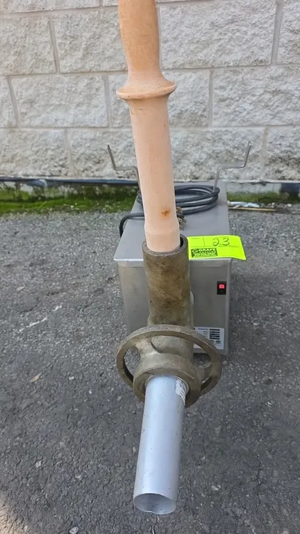 2014 Pro-Cut KG-12FS countertop meat grinder. Features stainless steel housing, grinder head assembly, sausage stuffing tube, and meat stomper. S/N: E