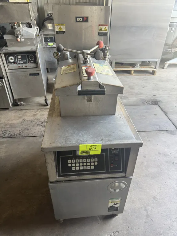 2010 BKI LGF-FC commercial natural gas pressure fryer. Features digital touchpad controls, pressure lid locking mechanism, built-in oil filtration sys