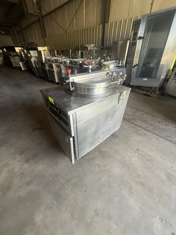 1993 BKI FKM electric pressure fryer. Features stainless steel construction, round fry pot with wire basket, locking lid with pressure gauge, and anal