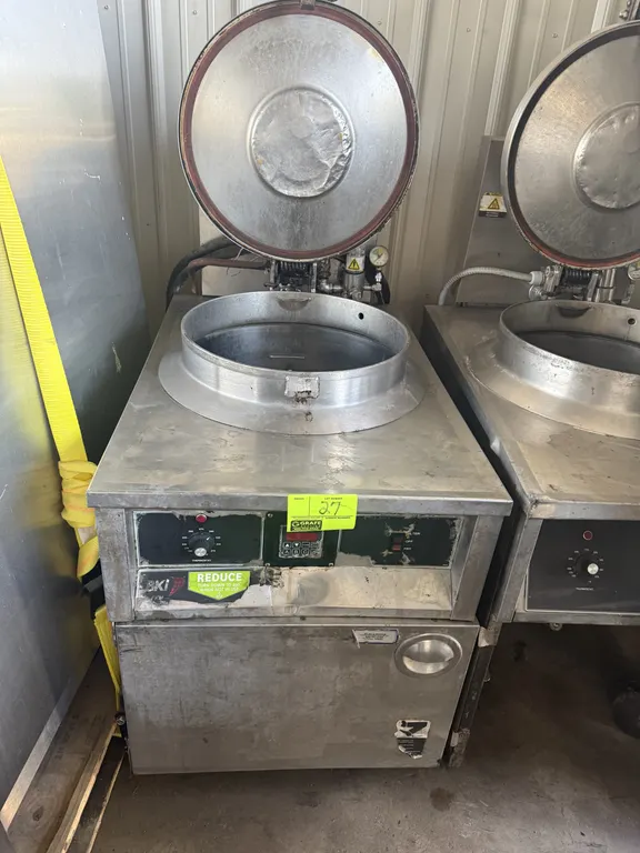2002 BKI FKM-F electric pressure fryer. Features stainless steel construction, locking hinged lid, and digital control panel. S/N: 113825. Electrical:
