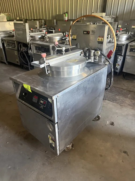 2011 BKI FKM-F commercial electric pressure fryer. Features stainless steel construction, round fry pot with wire basket, locking pressure lid assembl