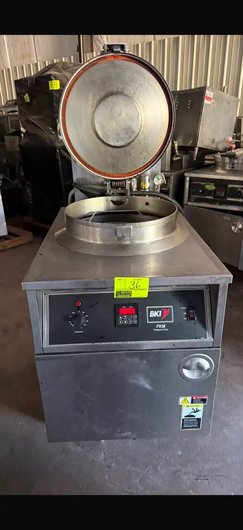 2013 BKI FKM-F commercial electric pressure fryer. Features stainless steel construction, round fry pot with wire basket, locking lid assembly with pr
