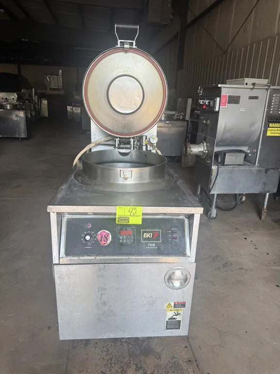 2010 BKI FKM-F commercial pressure fryer. Features stainless steel construction, locking pressure lid, round fry pot with wire basket, digital control