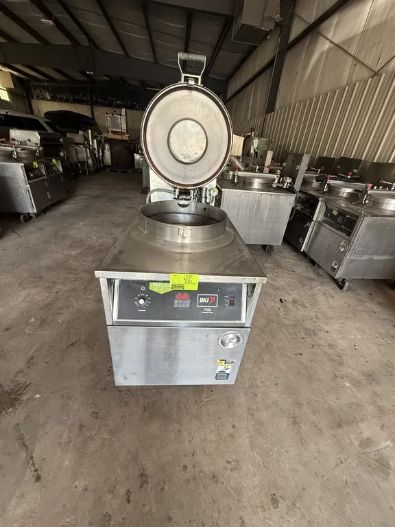 2011 BKI FKM-F commercial pressure fryer. Features stainless steel construction, digital controls, and a hinged locking pressure lid. S/N: 191100P-000
