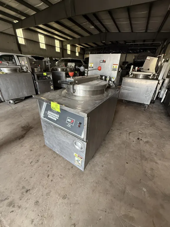 2010 BKI FKM-FC electric pressure fryer. Features digital touchpad controls, round fry pot with insert basket, locking lid assembly, and stainless ste