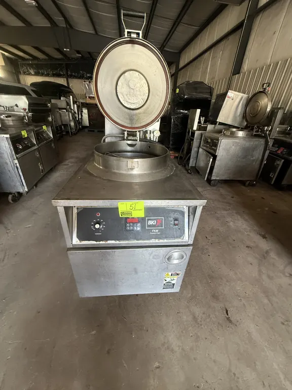 2010 BKI FKM-F commercial electric pressure fryer. Features stainless steel construction, digital controls, round fry pot with insert basket, and pres