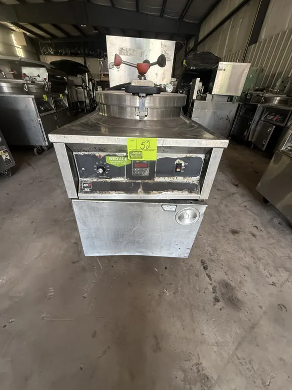 BKI FKM-E electric pressure fryer. Features stainless steel construction, locking lid, digital controls, and side-mounted oil return hose. S/N: 106733