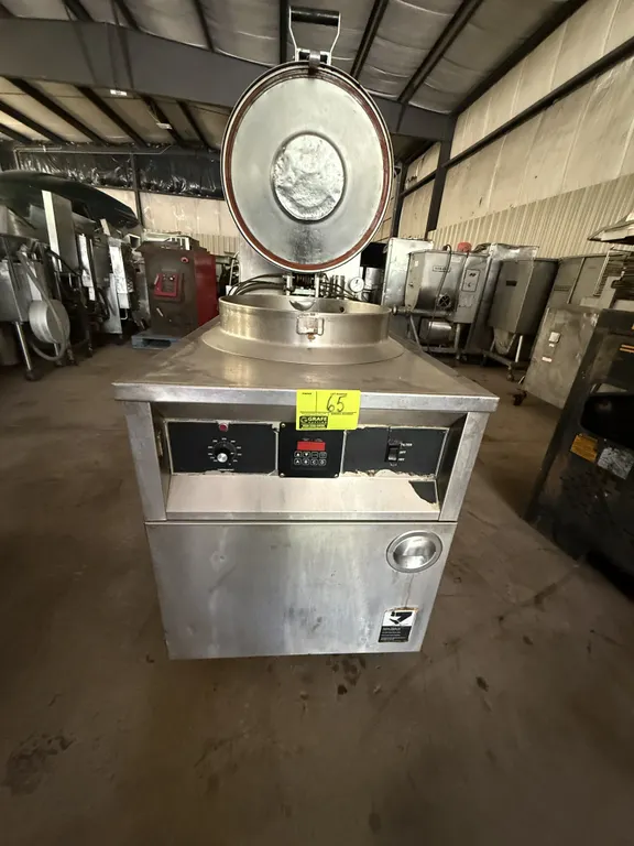 2002 BKI FKM-F commercial electric pressure fryer. Stainless steel construction. Features a round fry pot, locking lid assembly, digital timer control