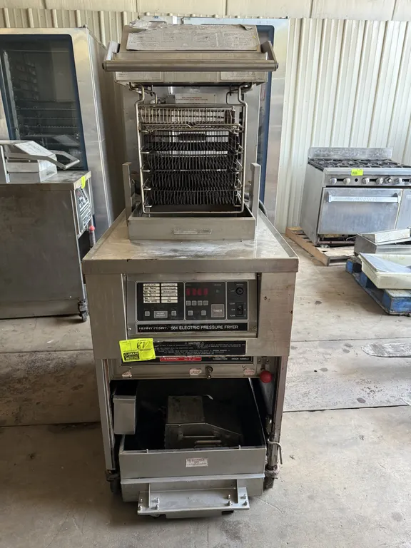 Henny Penny 581 electric pressure fryer. Stainless steel construction. Features digital programmable controls, multi-tier fry rack basket assembly, an