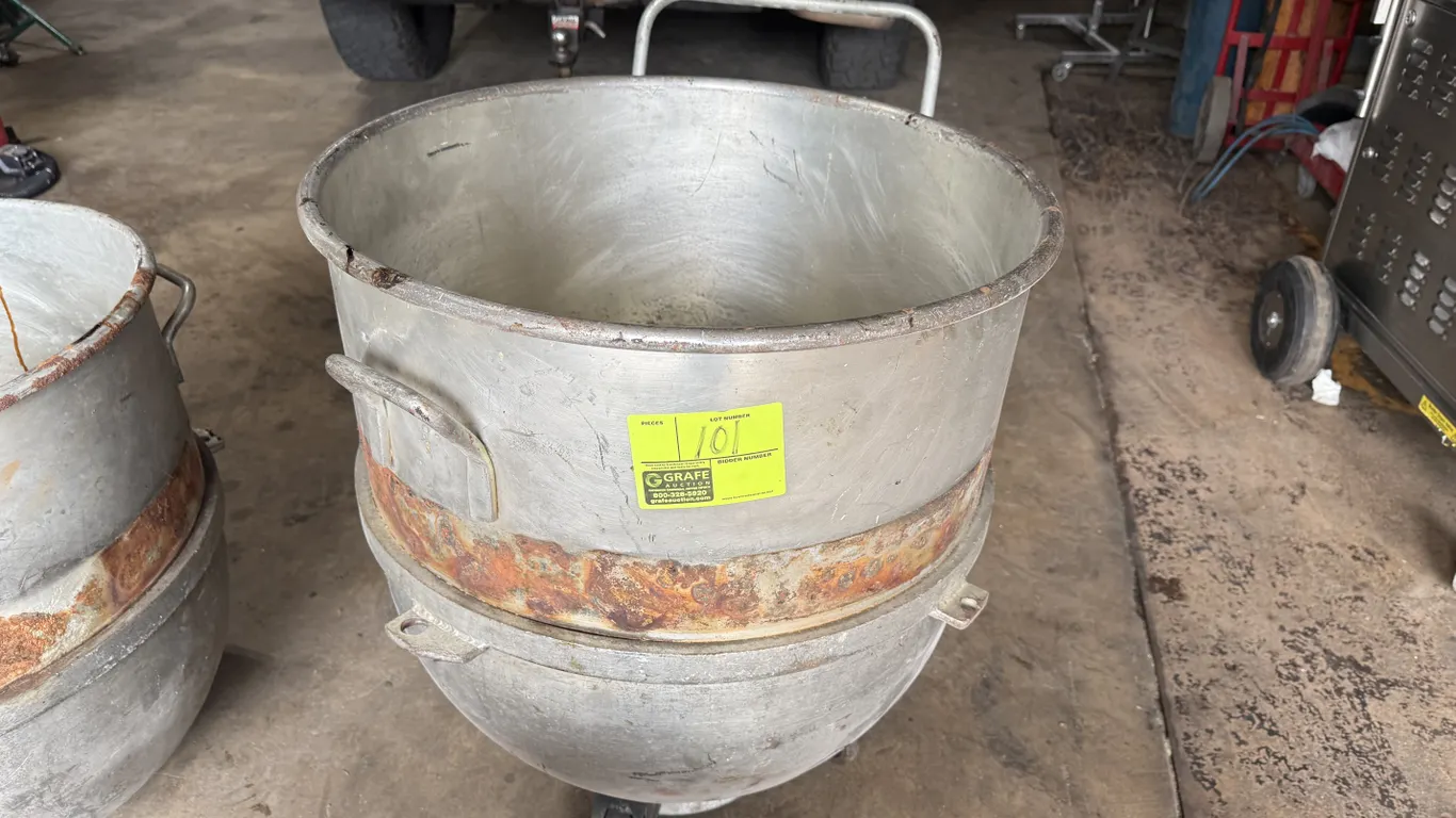Hobart 140-quart mixer bowl. Mounted on rolling bowl dolly with handle and casters. Note: Significant rust present on exterior band.