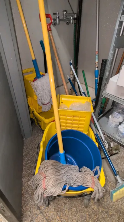 Polyethylene commercial mop buckets with wringers. Includes mop handles and mop heads. Yellow molded plastic construction with side-press wringers. Mo